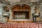 Majestic Abandoned Theater Interior with Vintage Ornate Design and Rows of Old Wooden Seats