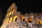 Majestic ancient Colosseum by night in Rome, Italy