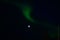 Majestic aurora borealis dancing around full moon