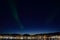 Majestic aurora borealis dancing on night sky over the arctic circle city of tromsoe
