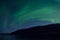 Majestic aurora borealis dancing over mountain island and fjord