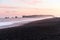 Majestic balck sand beach under pink sky in midnight light