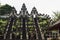 Majestic balinese culture Lempuyang temple in Bali - high stairs and sacred gate with towers decorated statues carved of stone.