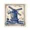 Majestic Blades: Vintage Stamp Illustrating a Dutch Windmill Landscape
