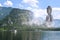 Majestic Buddha sculpture near lake and mountains on sunny day