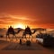 Majestic camel caravan against a desert sunset, Dubai skyline silhouette