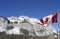 The majestic canadian rockies draped behind the Canadian Flag