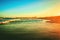 Majestic clear twilight sky over a wet sandy beach and a wavy seawater