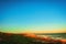 Majestic clear twilight sky over a wet sandy beach and a wavy seawater