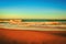 Majestic clear twilight sky over a wet sandy beach and a wavy seawater