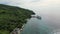 Majestic coastal Philippines small island town with road, truck, pier and ferry , aerial shot.