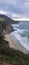 Majestic coastline with rocky cliffs and splashing waves of the ocean