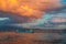 Majestic colorful cloud landscape over the sea and city at sunset. Izmir, Turkey