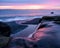 Majestic colorful sunset over a Sandcut waterfall in Sandcut Regional Park, Shirley, Canada