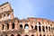 Majestic Colosseum in Rome against blue sky, Italy