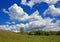 Majestic cumulus clouds over a summer field