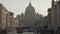Majestic dome of Saint Peter\'s Basilica towering over city street, slow motion