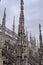 Majestic Duomo di Milano Grand Cathedral with intricate architectural designs against a clouded sky