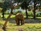 Majestic elephant walking across a grassy plain with trees in the background