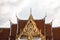 Majestic entrance to a grand building featuring an intricate golden facade in Bangkok, Thailand