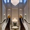 Majestic Entryway: A grand entryway with a sweeping staircase, a crystal chandelier, and a massive floor-to-ceiling mirror to cr