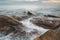 Majestic Evening Seascape: Dramatic Waves Collide with Island Rocks in Eastern Thailand at Sunset