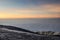 Majestic glacier-covered mountain on the background of the sea at sunset