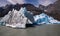 Majestic iceberg in the middle of an aquatic scene with snow-covered peaks