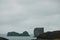 majestic icelandic landscape with cliffs in ocean and cloudy sky, vik dyrholaey, reynisfjara