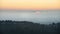 Majestic landscape image of cloud inversion at sunset over Dartmoor National Park in Engand with cloud rolling through forest on