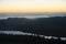 Majestic landscape image of cloud inversion at sunset over Dartmoor National Park in Engand with cloud rolling through forest on