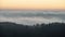 Majestic landscape image of cloud inversion at sunset over Dartmoor National Park in Engand with cloud rolling through forest on