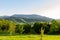 Majestic landscape of mountains and Meadow. Cycling mountain road. Misty mountain road in high mountains.. Cloudy sky with mount