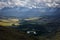 Majestic landscape. Rain clouds snowy peaks beautiful sky with sun rays. Storm sweeps over Kurai steppe in Altai mountains. Harsh