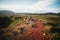 majestic landscape with red ground, rocks and grass at sunny