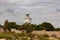 Majestic lighthouse with clear blue sky and grass in foreground