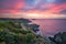 Majestic lighthouse perched atop a cliff overlooking a tranquil ocean