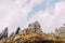 Majestic looking rocky mountain top with cloudy sky on background