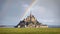 Majestic Mont Saint-Michel castle under a rainbow, France
