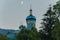 A majestic moon in a cloudless sky above the dome of the church