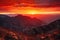 majestic mountain range, with the sun setting behind, and fiery reds and oranges in the sky