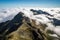 majestic mountain range viewed from above, with clouds obscuring part of the view