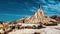 Majestic mountain stands proud in the middle of a vast desert expanse. Bardenas Reales, Spain.