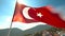 Majestic mountain waves flag in clear sky, symbolizing Turkish patriotism generated by AI