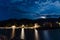 Majestic night sky with a full moon casting a brilliant glow over a tranquil body of water