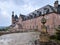 Majestic red brick castle-like Mont Sainte-Odile
building against a clouded sky