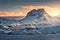 Majestic scene with high snow covered mountains at sunset