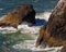 Majestic scene of an ocean shoreline featuring crashing waves over rocks