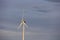 Majestic scene of several birds soaring through the air with a large wind turbine in the foreground