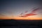 Majestic scene of winter mountains surrounded by fog and bright clouds during twilight